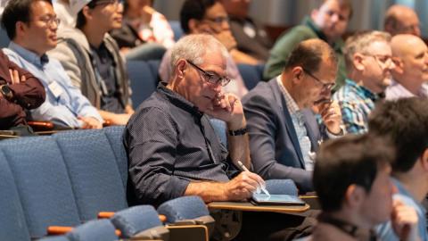 attendees taking notes