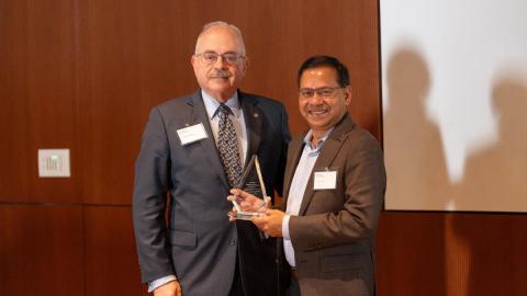 Dean Pisano presenting plaque to Sujit